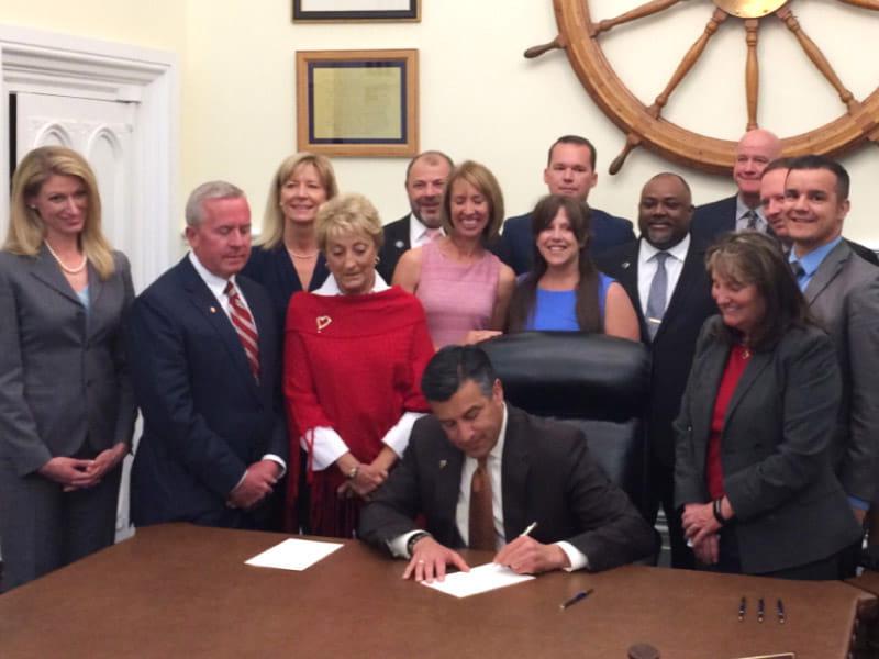 Representatives from the American Heart Association’s You’re the Cure grassroots network join Nevada state legislators and then-Gov. Brian Sandoval on May 15, 2017, in Carson City as he signs Assembly Bill 85 into law. 