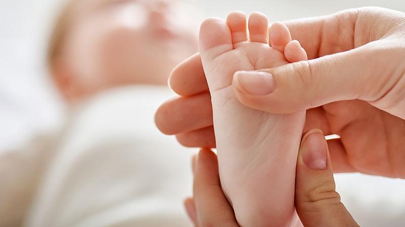 doctor holding a baby's foot